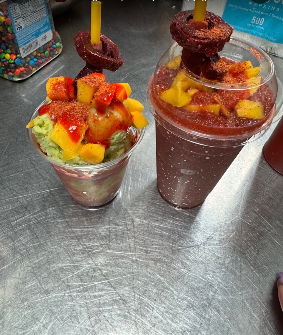 Two fruit and chile treats topped with mango